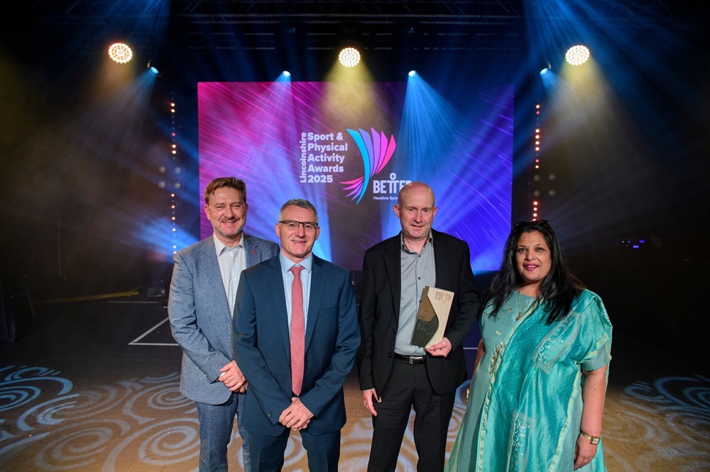 Slea Paddlers collect the Active Club Award, presented by judge Batul Dungarwalla